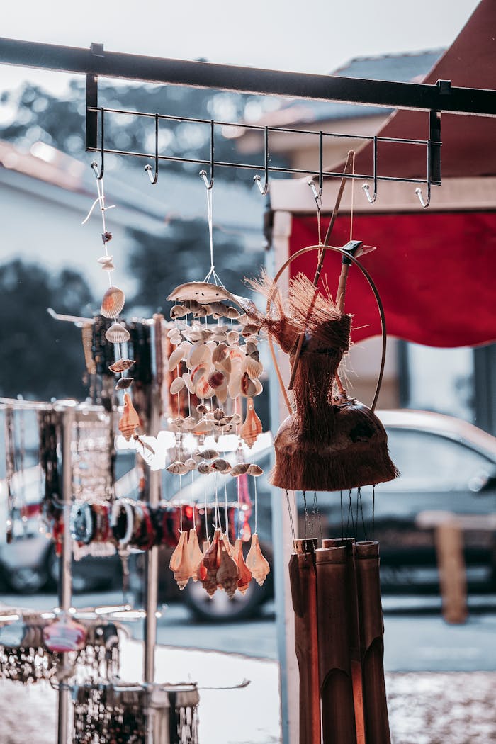 About Decoration made of seashells hanging near accessories and souvenirs selling on local market